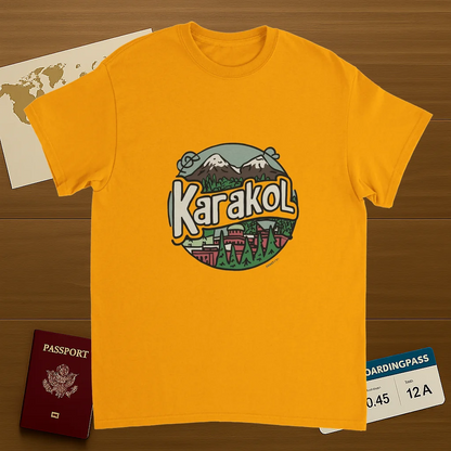 gold Karakol Kyrgyzstan Unisex Travel T-Shirt on wooden background with world map, passport, and boarding pass
